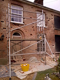 Carefully removing damaged bricks ready for replacement and re-pointing.